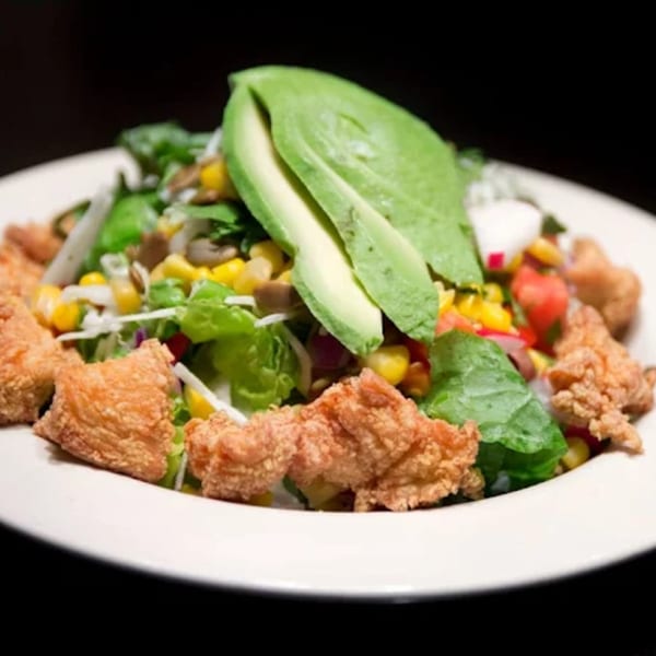 Misto Caffe & Bakery's salad with fried chicken, avocado, corn, and mixed greens.