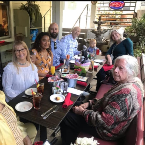 A multi-generational family enjoys breakfast together at Misto Caffe & Bakery's outdoor patio.