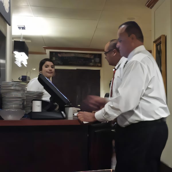 Misto Caffe & Bakery staff, a woman and two men, working behind the counter.
